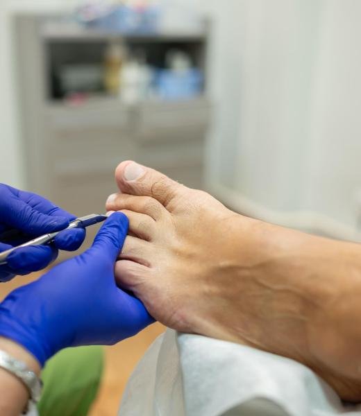 concept of male pedicure, foot pedicure, cosmetologist makes classic pedicure for an elderly male client.